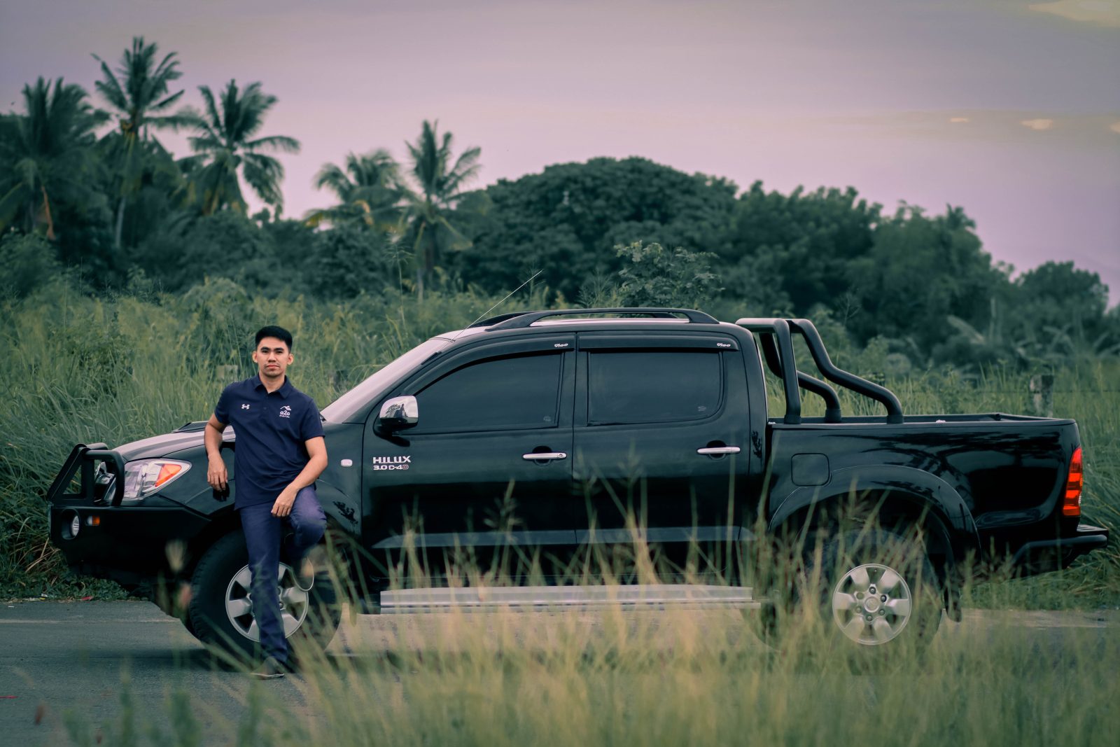 Christian Lugatiman with a pickup truck in a field